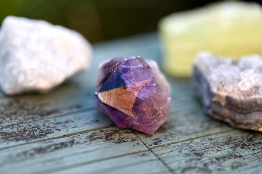 a collection of crystals laid on wood