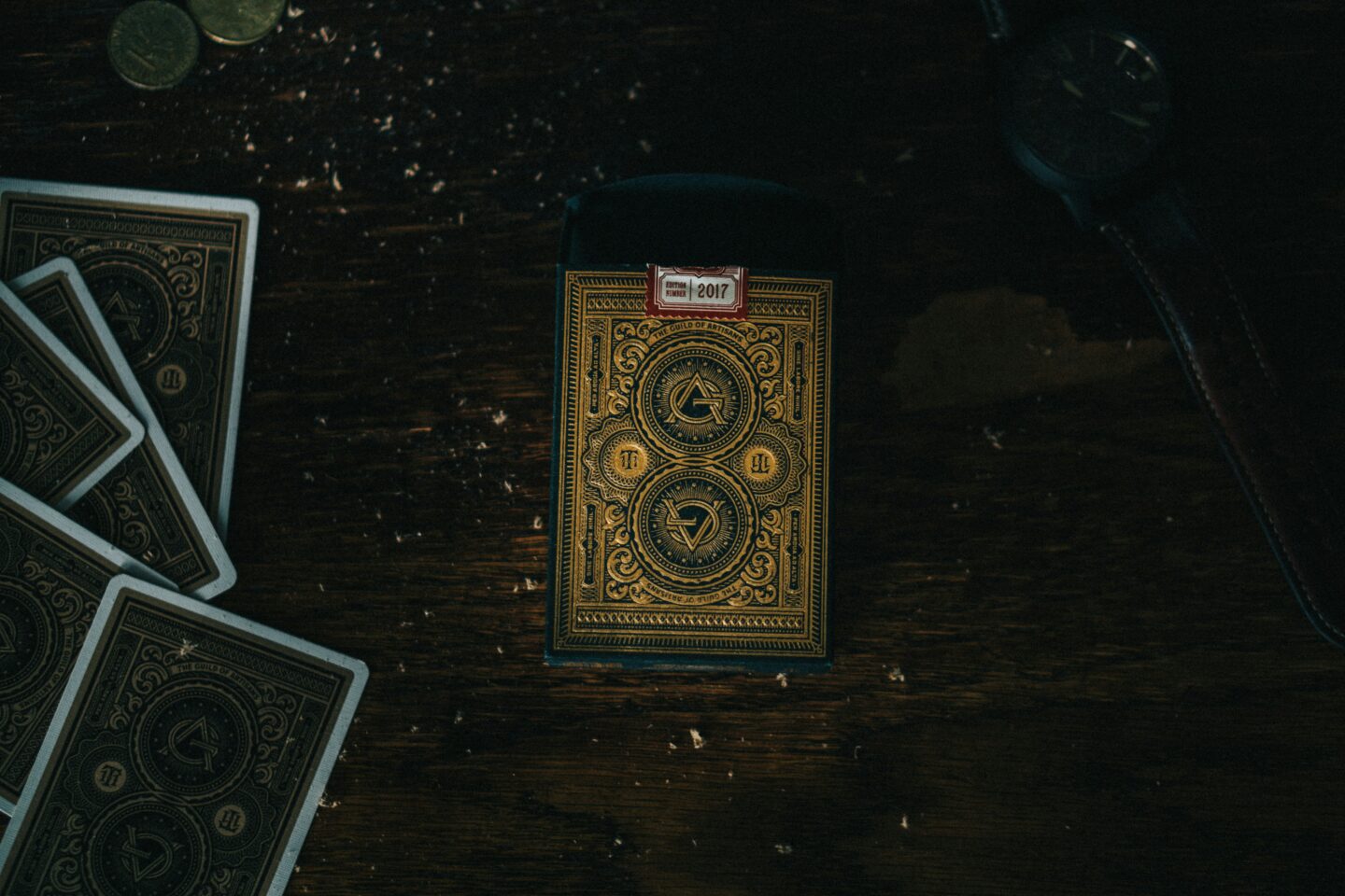 tarot deck with gold and black pattern on dark wood