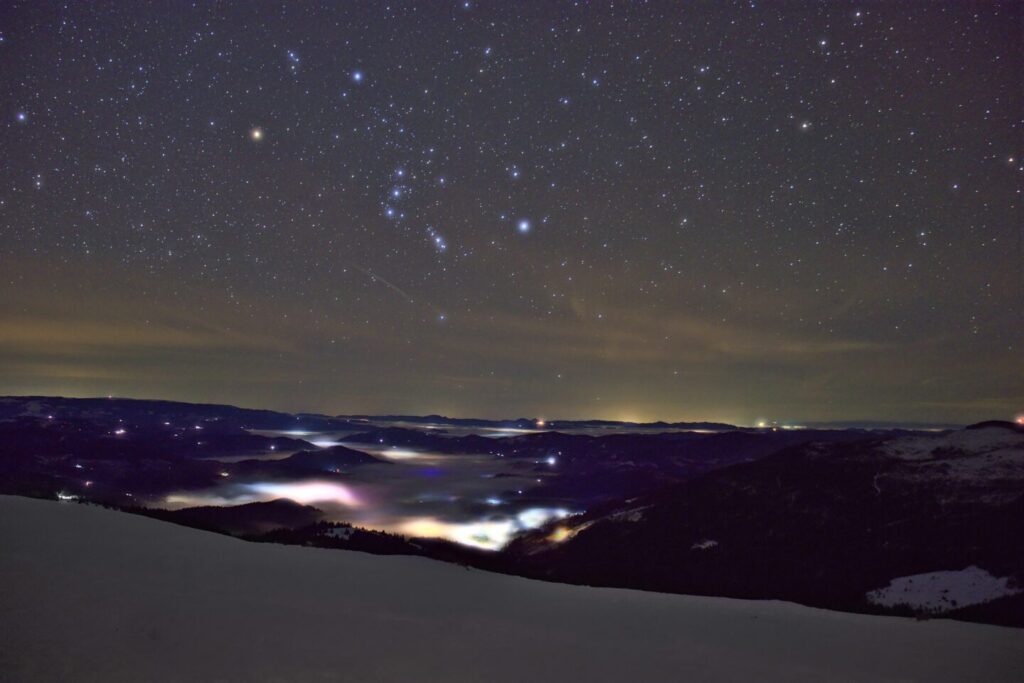 photo by Adrian Mag, of water, stars, and sky