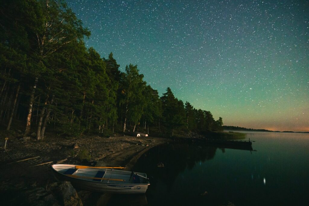 paul-volkmer-photo-water-trees-starry night-boat at the shore